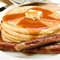 Breakfast of coffee, pancakes and sausage