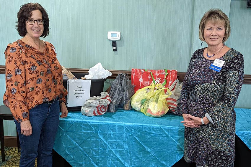 Karen Healy (MCCS) and Teresa Echols (ABWA) with donated food