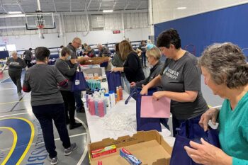 A record number of thirty-six volunteers assemble the bags!